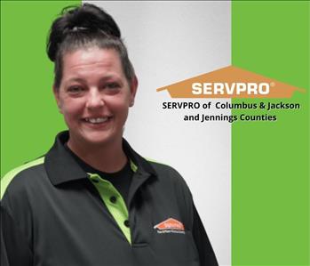 Woman smiling with green and white background and a SERVPRO logo