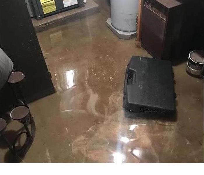 Flooded basement with water damaged items 